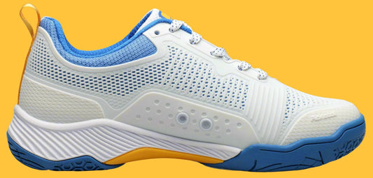 White pickleball shoe with blue accents on a yellow background