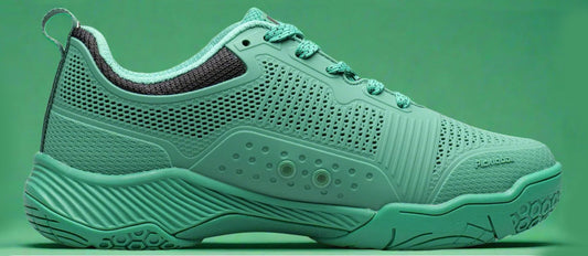 Green pickleball shoe on a green background