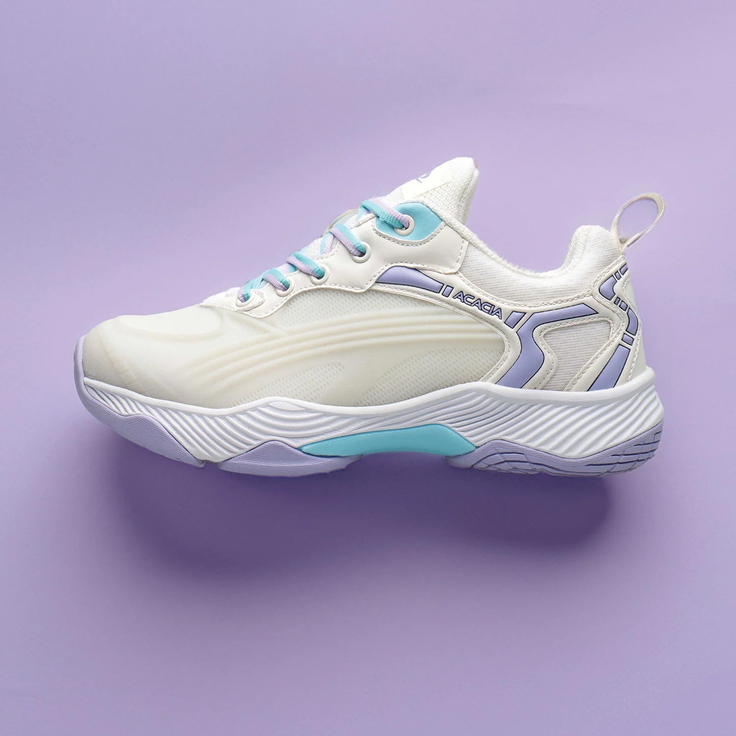 Dreanshot white and light blue pickleball shoe on a purple background