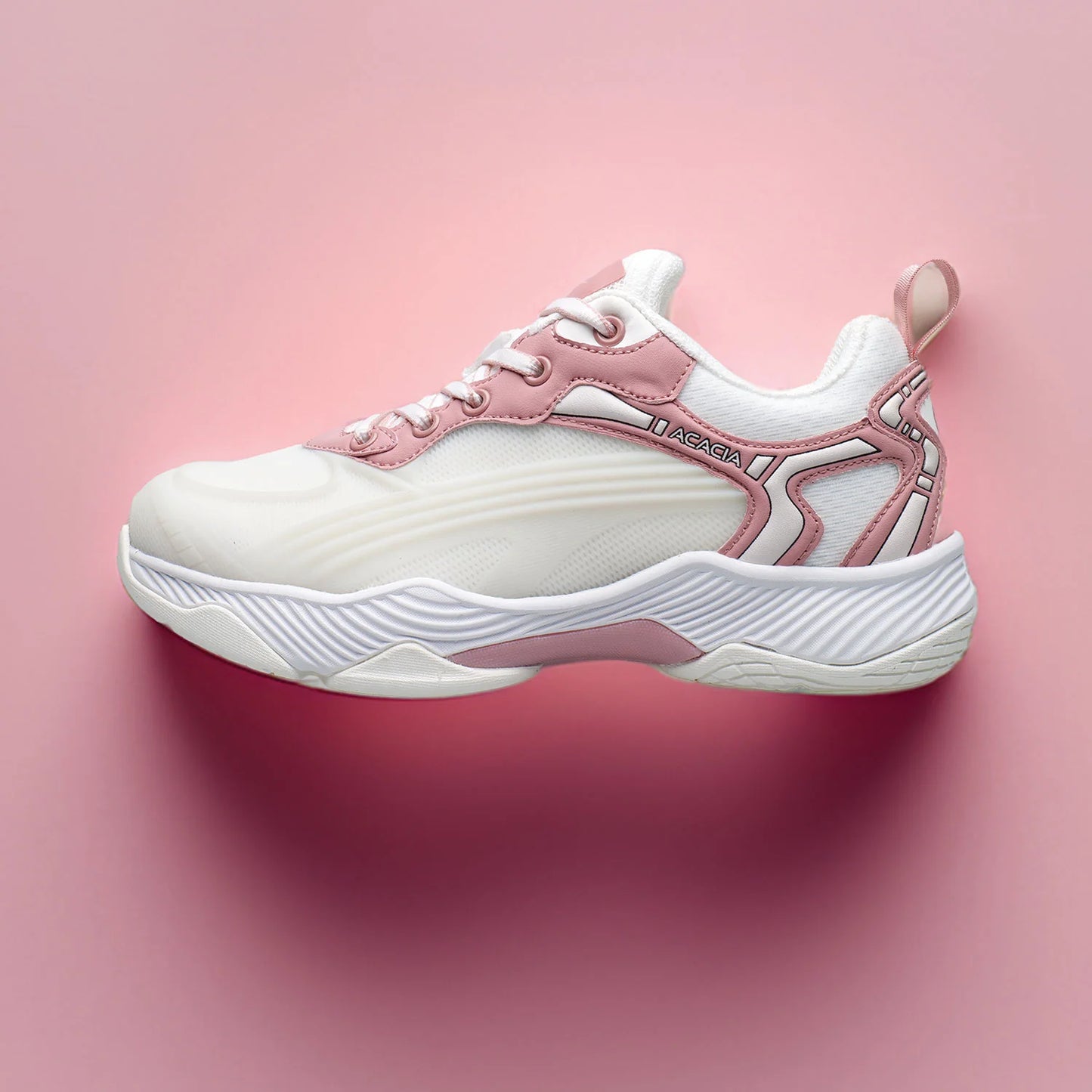 Dreamshot white and pink pickleball shoe on a pink background