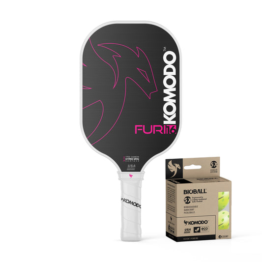 Pink Furi 16mm Komodo pickleball paddle and 4 pack of Bioball pickleballs on a white background