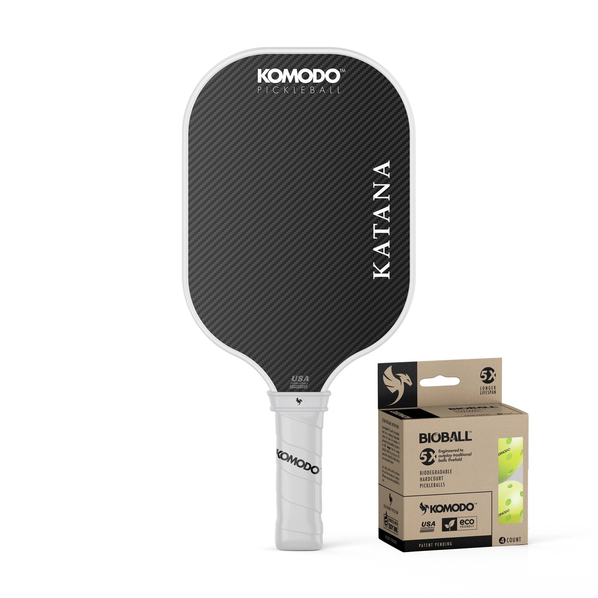 Komodo 16mm white & black Katana pickleball paddle with a 4 pack Bioball packaging on a white background